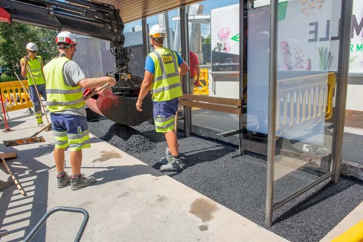 innsbruck austria july 27 2020 workers work asphalting tram stop with rake shovel_646135 3796