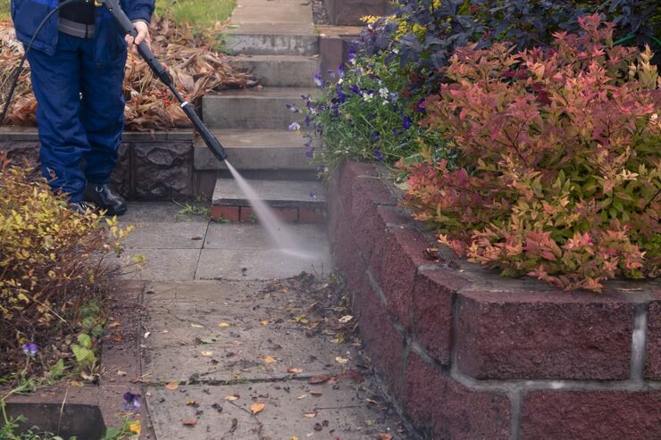 man washes garden path with high pressure washer autumn work garden_332246 703