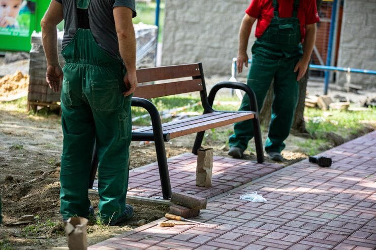 physical workers set up park bench designated spot city park_357949 818
